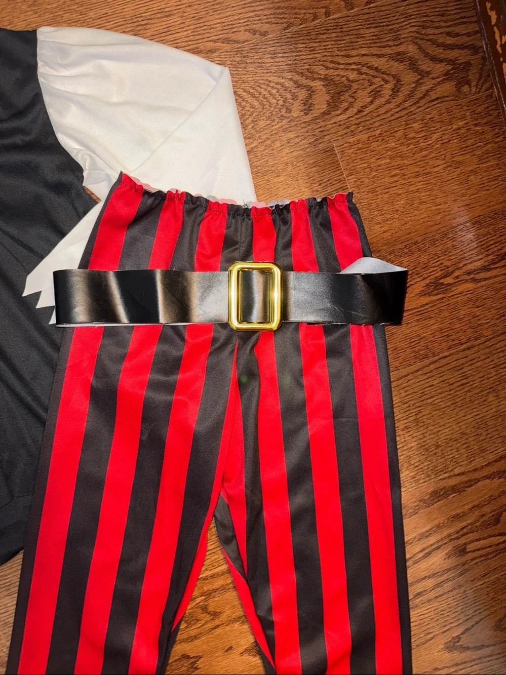 Size s/6-8 pirate costume. Shirt, Pants, Belt, Boot Covers, Scarf, wrist cuffs.